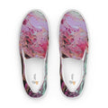 Pair of slip-on shoes with colorful abstract design on a white background
