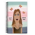 Notebook with a stylized illustration of a woman and butterflies on the cover