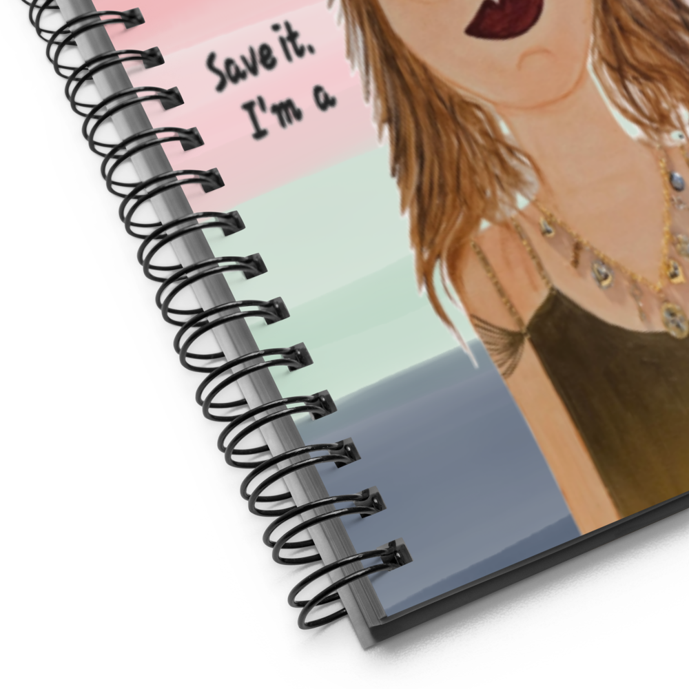 Notebook with a spiral binding and a colorful illustration of a woman on the cover.