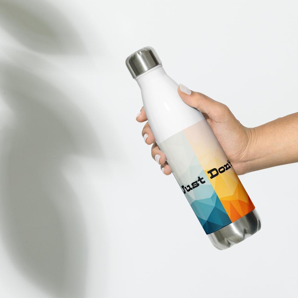 A hand holding a white insulated water bottle with a silver metal cap and base. The bottle features a geometric low-poly style graphic in shades of blue, yellow, and orange, with the text 'Just Do It' printed on the front.