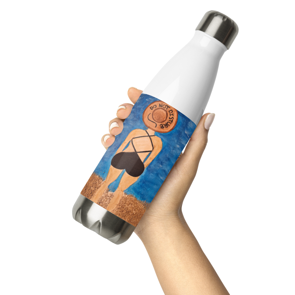 A hand holding a stainless steel water bottle with a white upper body, silver cap and base, and a blue beach-themed wrap label showing a woman in a black bikini on sand.