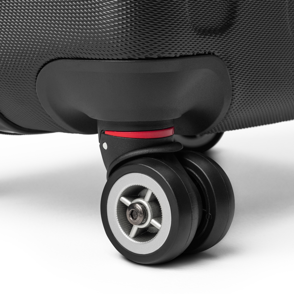 Close-up of a suitcase wheel on a light gray background