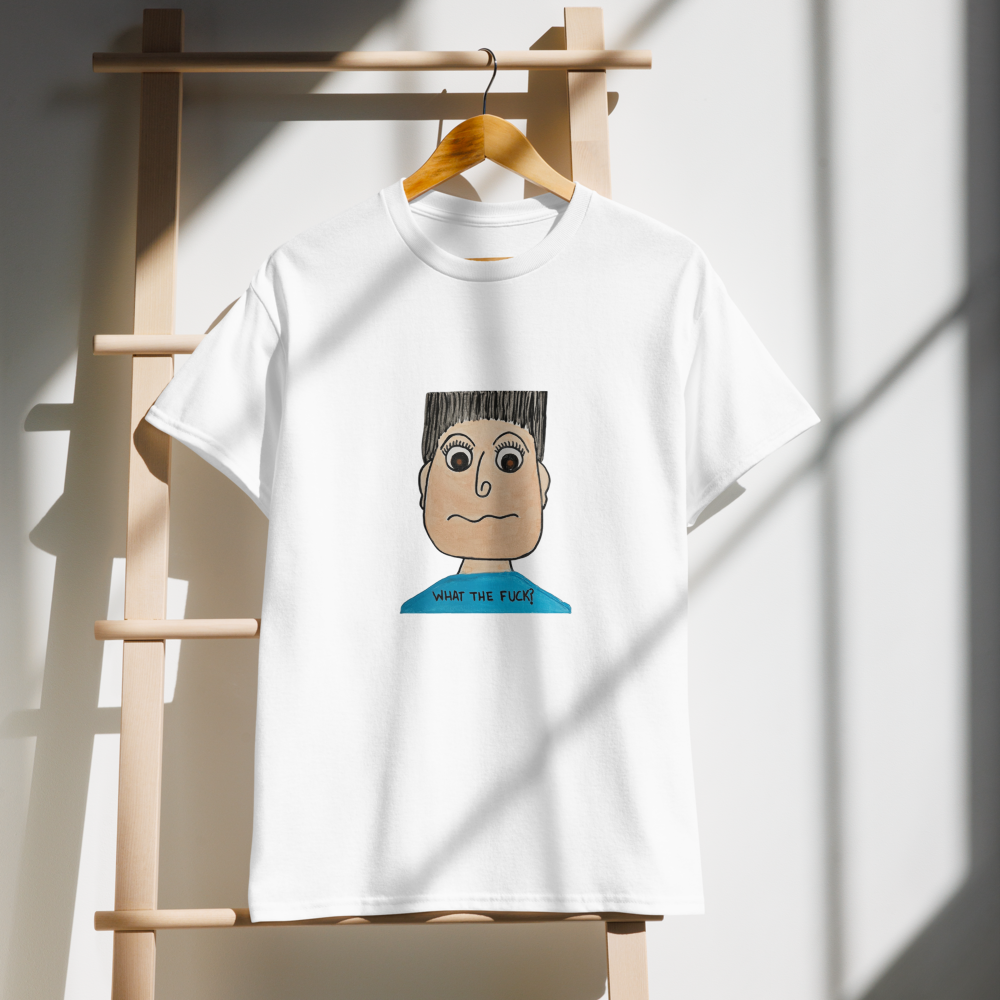 White t-shirt with a cartoon character design on a wooden hanger against a white wall.