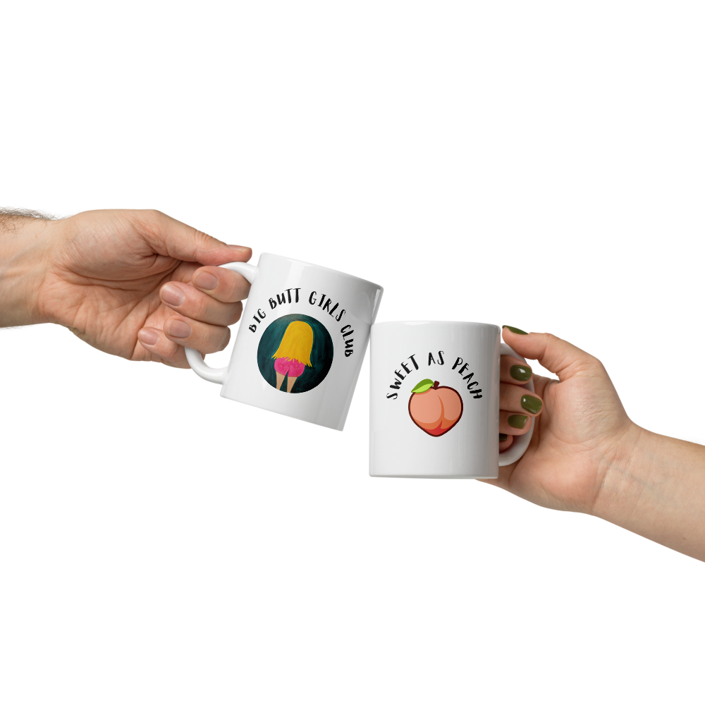 Two white mugs held by hands with humorous designs on a white background