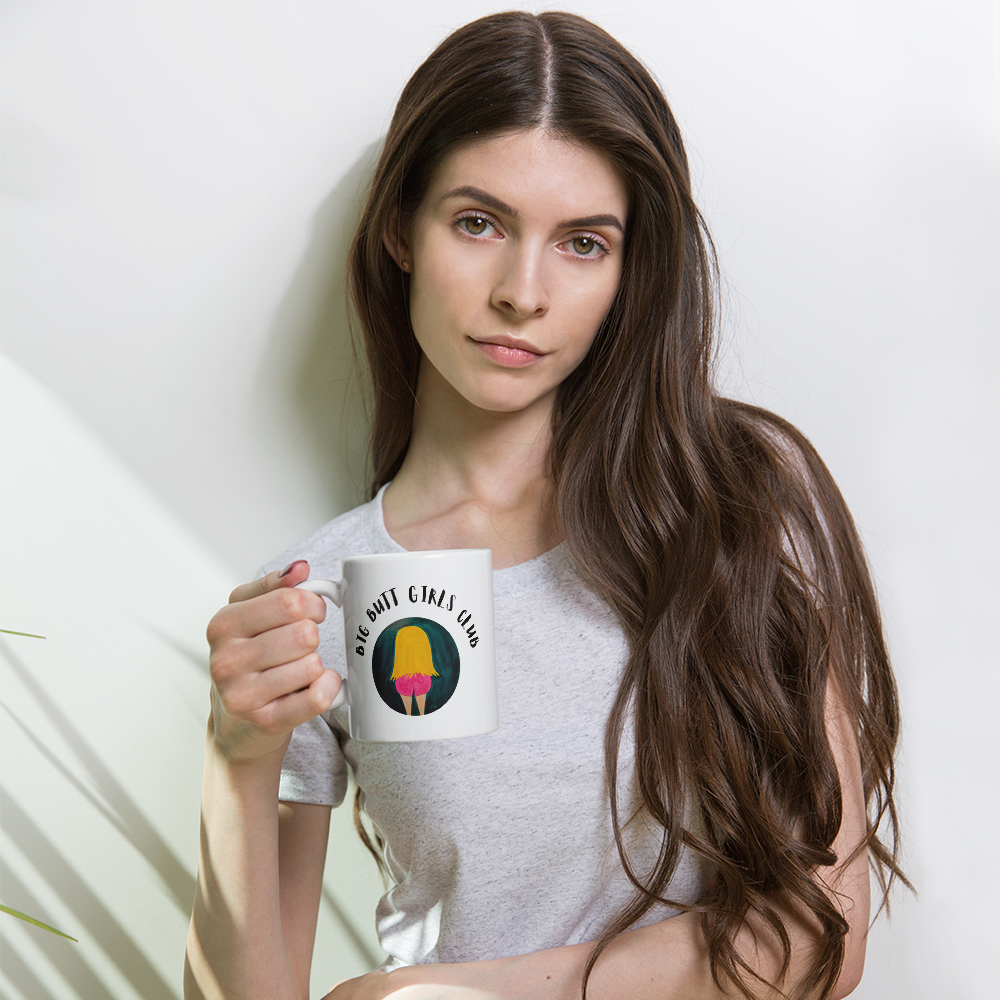 Woman holding a mug with a graphic design on a plain background