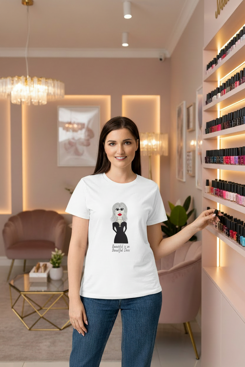 a woman in a nail salon wearing a white t-shirt with a catchy phrase