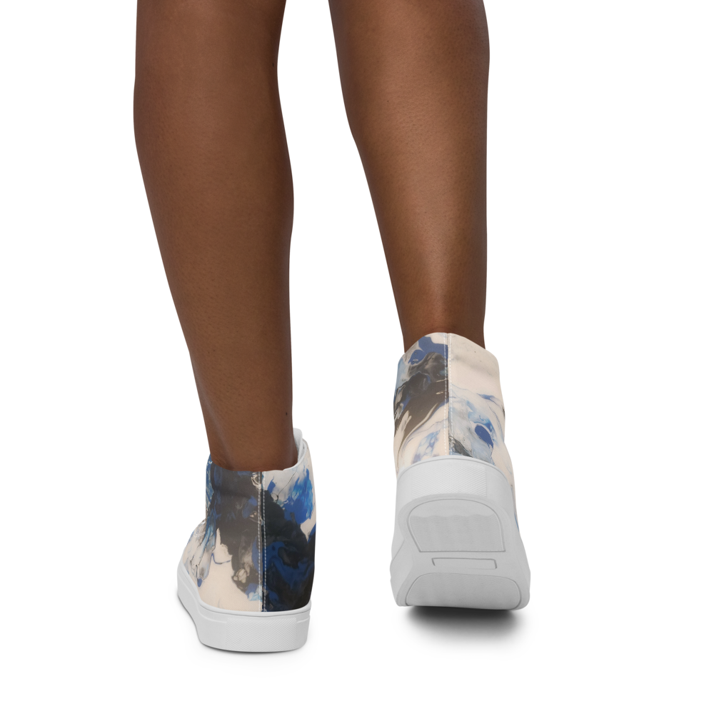 White sneakers with blue floral pattern worn by a person on a white background