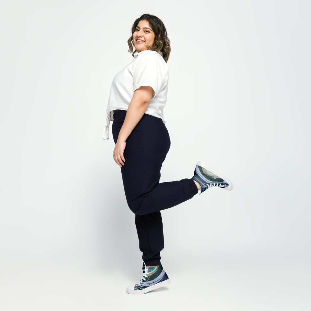 Woman wearing a white shirt, navy pants, and colorful sneakers on a white background