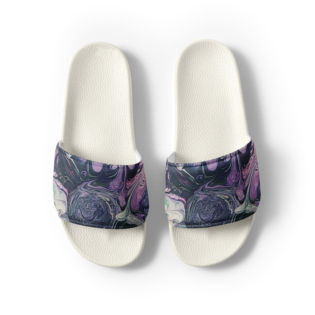 Pair of white slides with purple and blue marbled straps on a light gray background