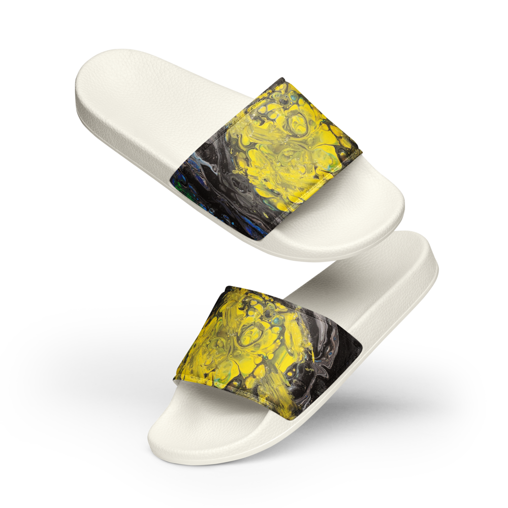 White slide sandals with abstract yellow and black straps on a white background