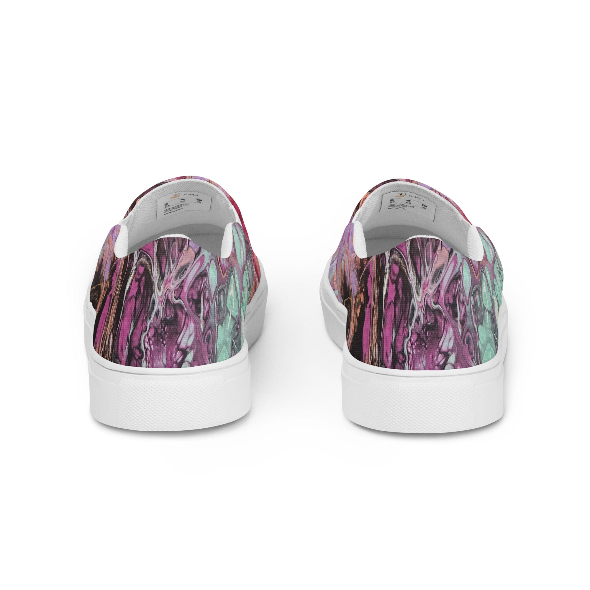 Pair of slip-on shoes with colorful abstract design on a white background