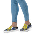 Person wearing colorful slip-on sneakers with a white background