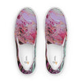 Pair of slip-on shoes with colorful abstract design on a white background